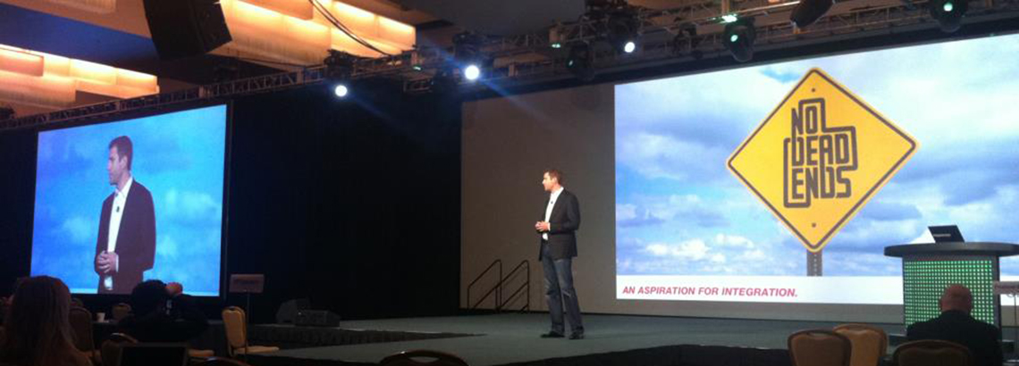 Matt Walsh presenting the 'No Dead Ends' integration philosophy on a conference keynote stage